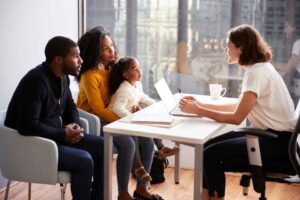 A father, mother, and daughter meet with a special education advocate.