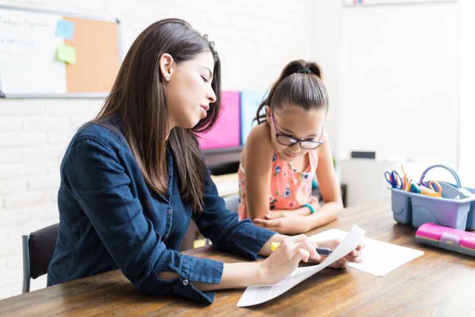 A way to become a private tutor is working in home like this young woman with elementary age student