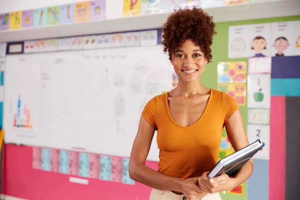A smiling teacher in her classroom.