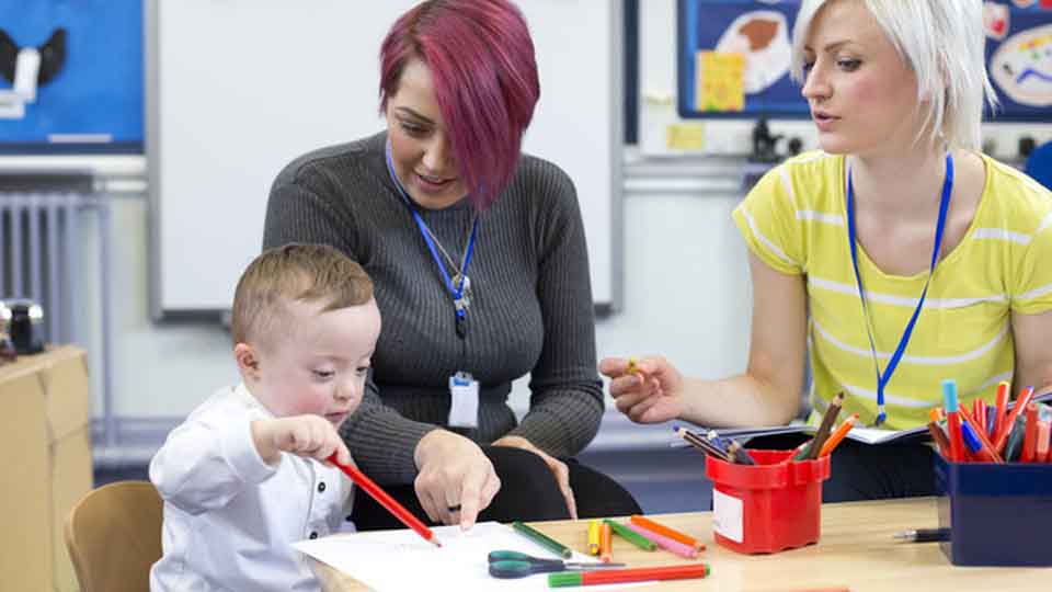 Two women taking care of a toddler