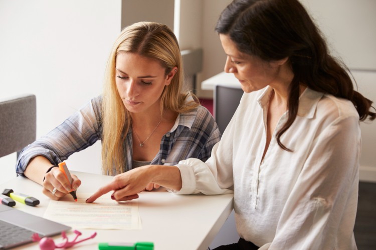 A tutor works with a student with dyslexia.