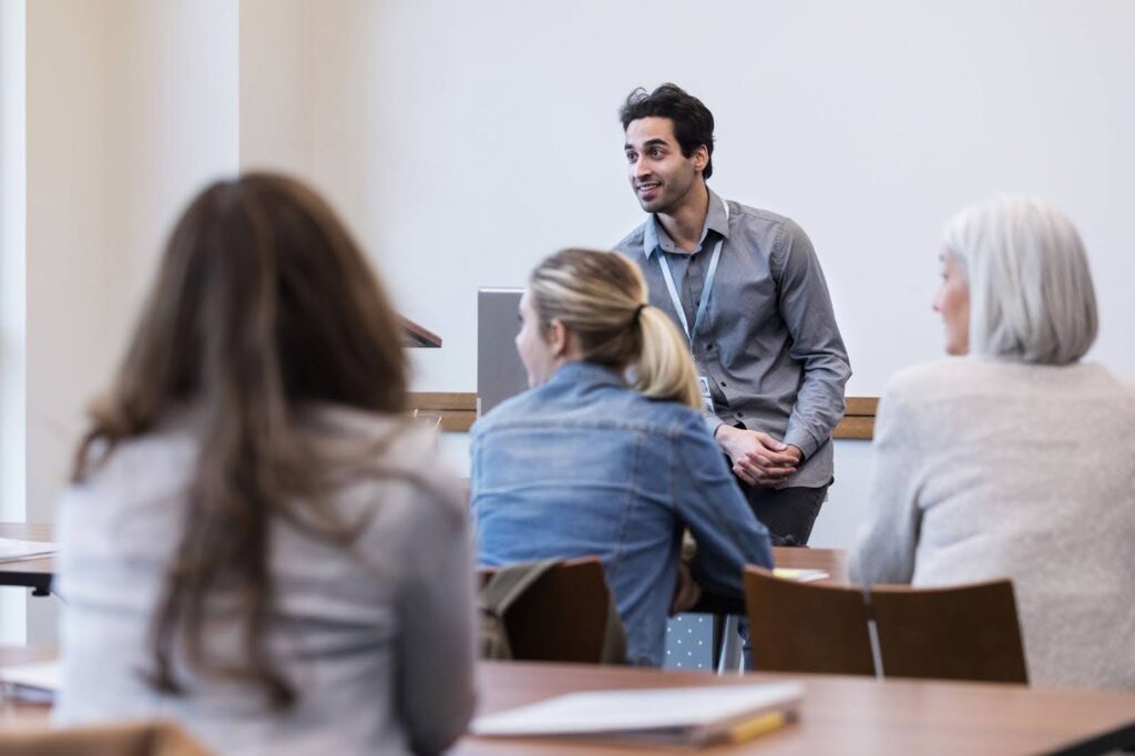 A school principal conducts a staff meeting.