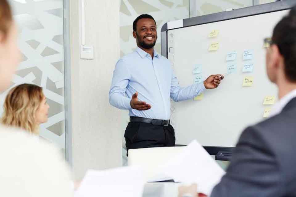 A man teaching a class of adults
