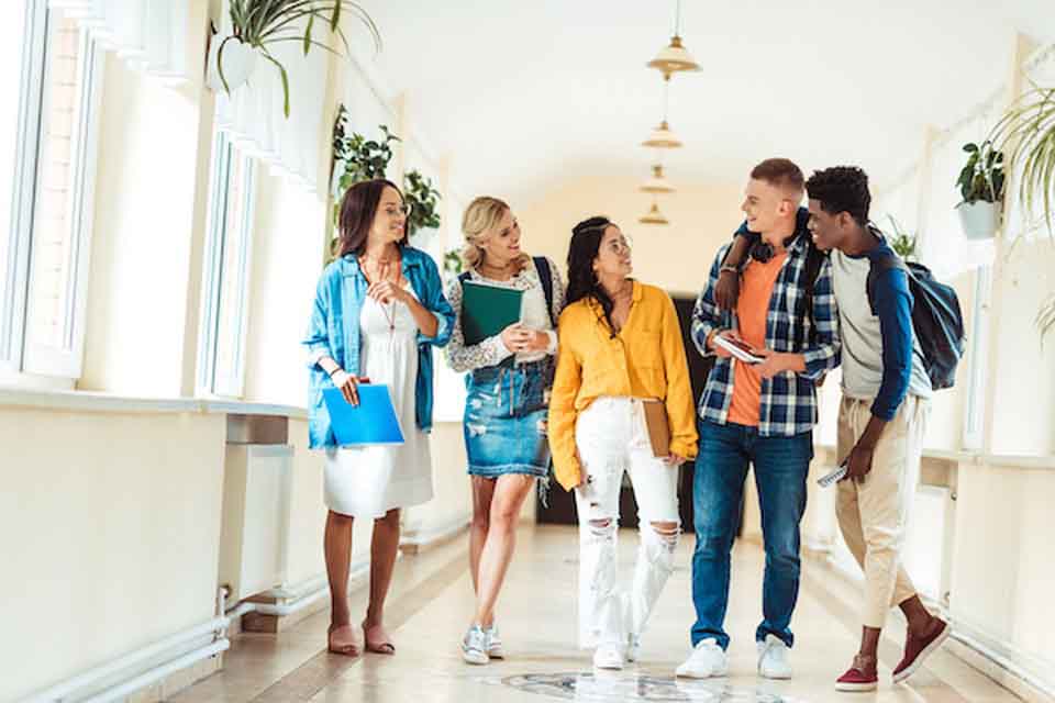 a group of teens in a corridor