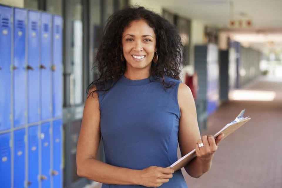 A female leader standing in a school corridor