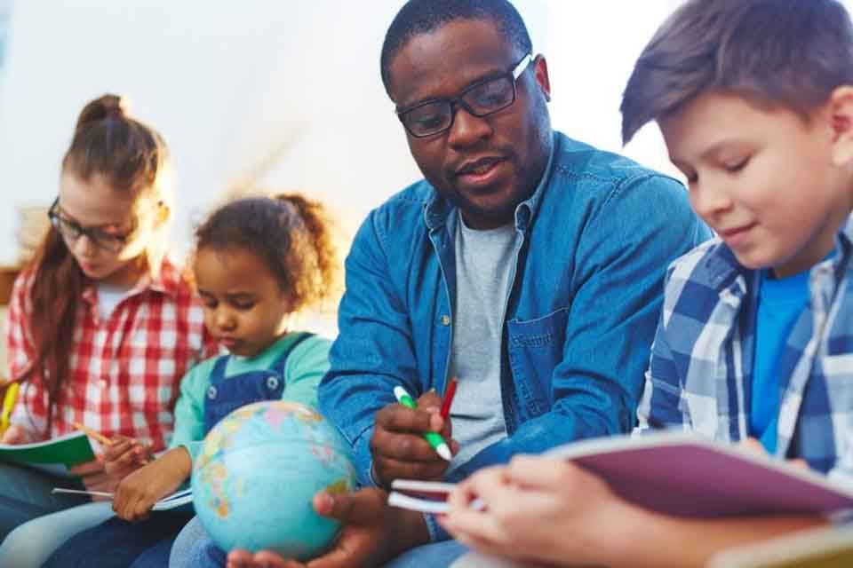 A teacher helps a student.