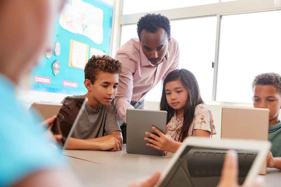 A teacher works with a small group of students.