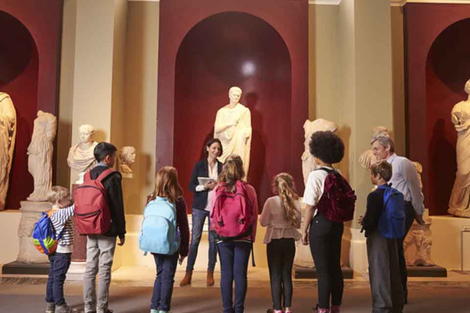 A group mixed of adult and children visiting a museum