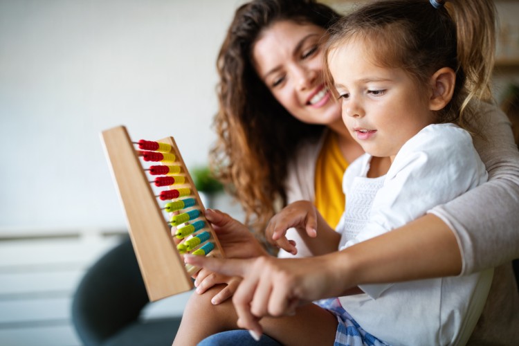 An early childhood educator interacts with a young child.
