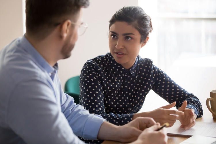 An instructional coach talks with a teacher.