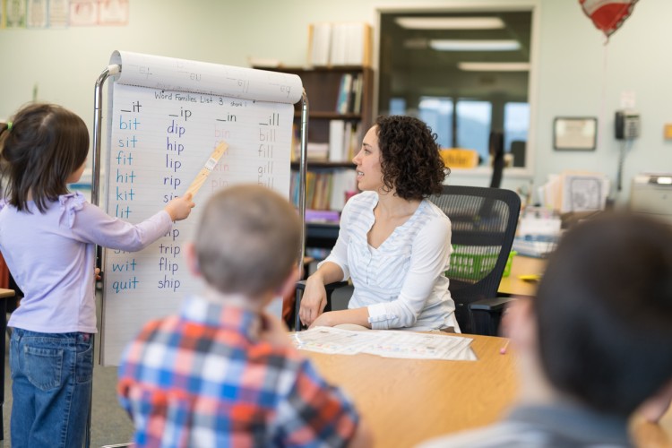 A teacher encourages a student during a lesson.
