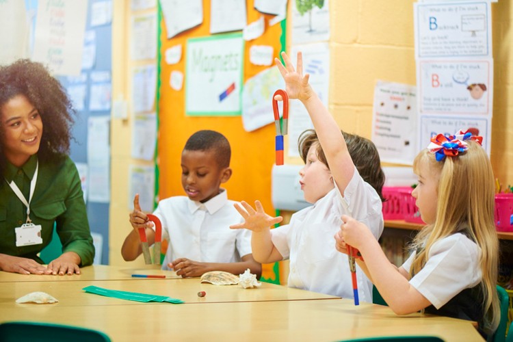 Elementary school teacher teaches students in a classroom.