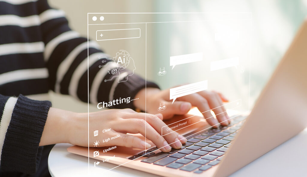 A closeup of hands typing on a laptop where AI is being used interactively.