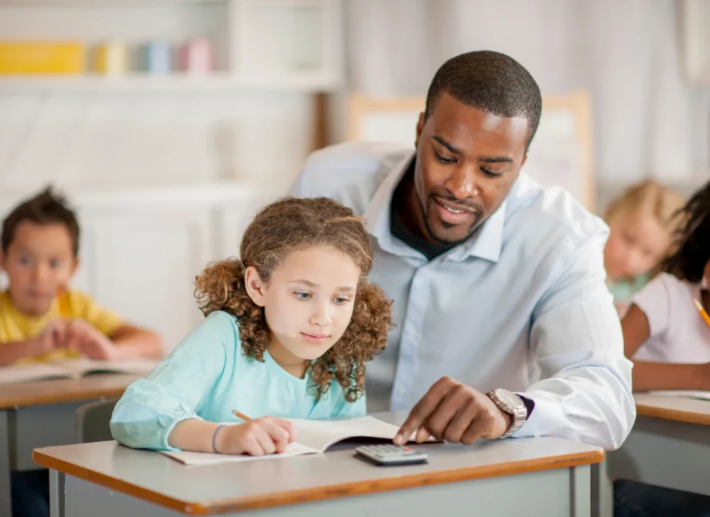 Teacher teaching a student in the classroom.